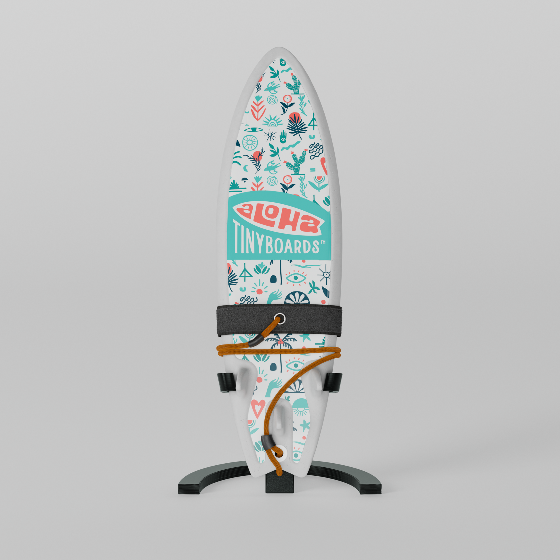 Mini foam surfboard on a black plastic stand made from recycled materials, branded Aloha Tinyboards™
