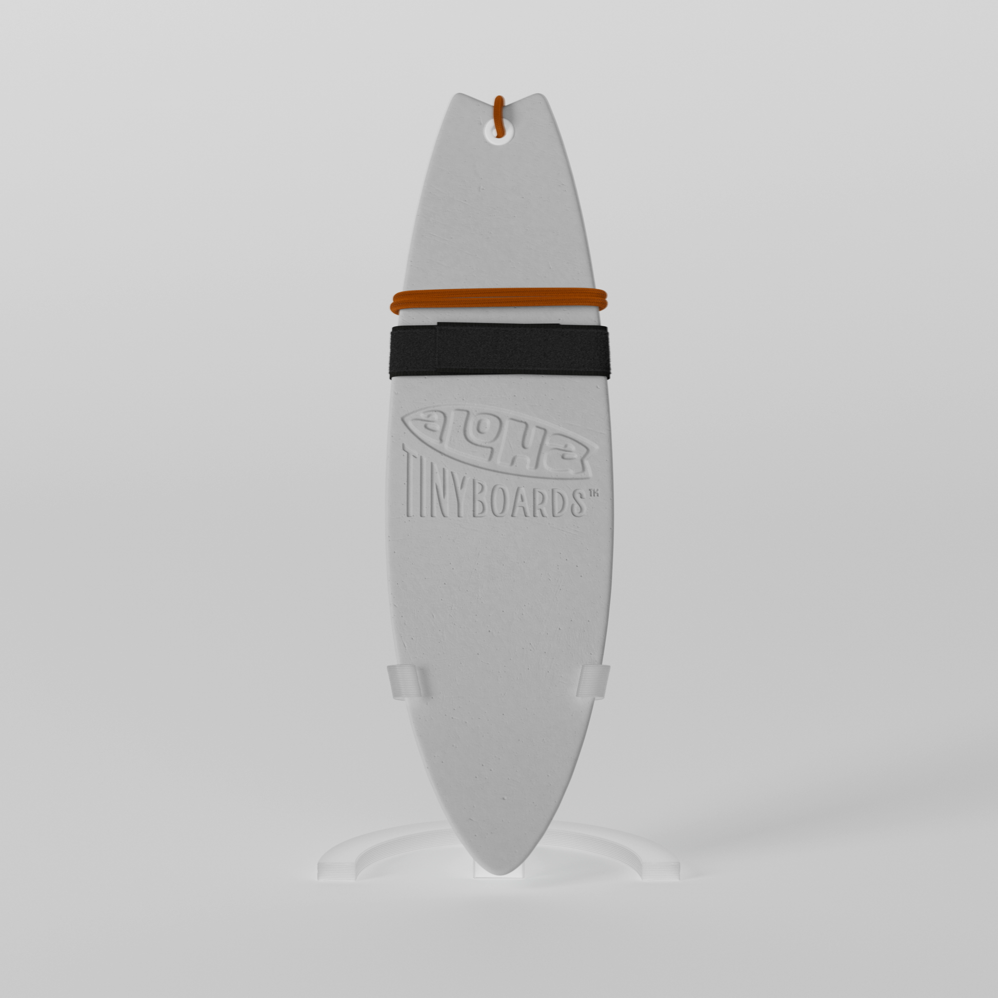 Mini foam surfboard on a clear plastic stand made from recycled materials, branded Aloha Tinyboards™