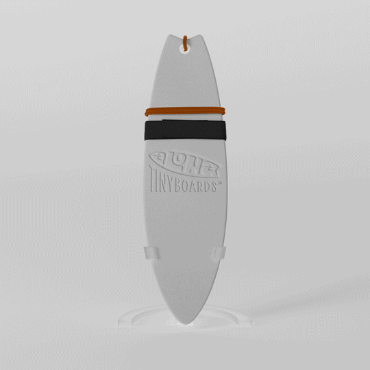 Mini foam surfboard on a clear plastic stand made from recycled materials, branded Aloha Tinyboards™