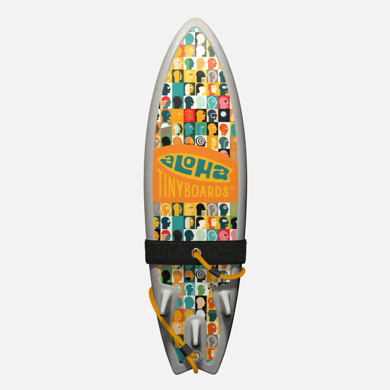 Animated GIF of Aloha Tinyboards foam finger surfboard rotating 360° showing Heads multicolored head-silhouette grid pattern.