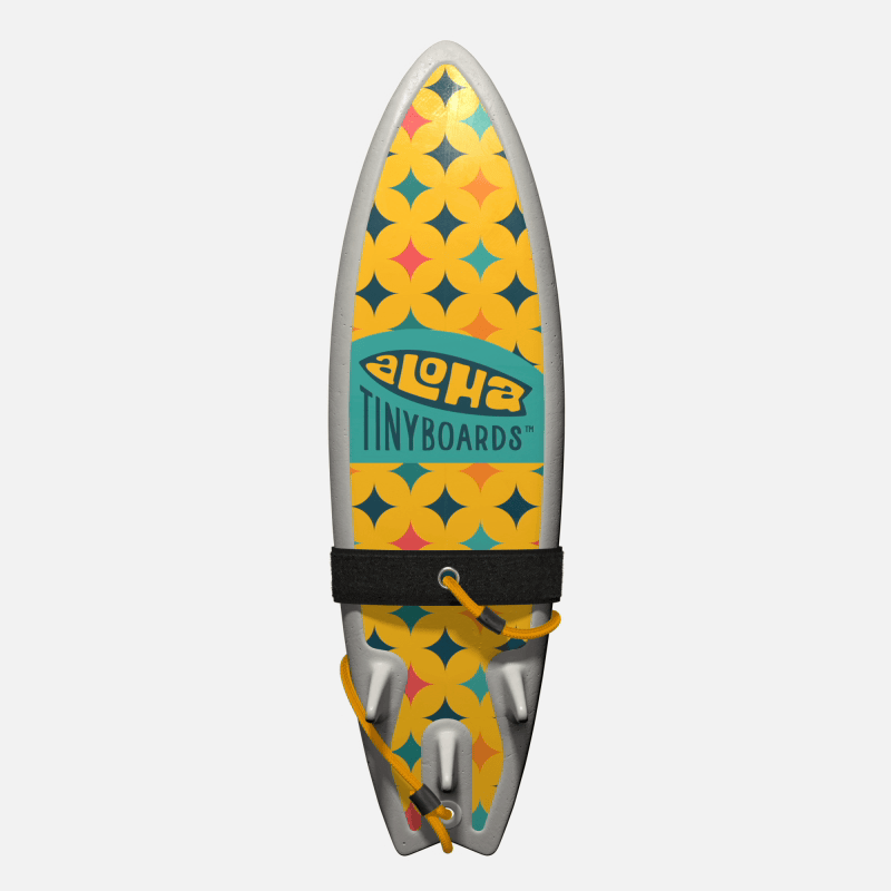 Animated GIF of Aloha Tinyboards foam finger surfboard rotating 360° showing Katsu yellow-and-orange geometric star motifs.