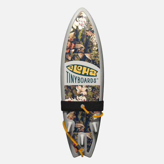 Animated GIF of Aloha Tinyboards foam finger surfboard rotating 360° showing Locals Only vintage botanical collage with white and orange florals.