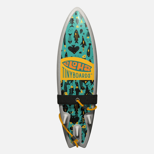 Animated GIF of Aloha Tinyboards foam finger surfboard rotating 360° showing Tako stylized black-and-yellow fish silhouettes on teal.